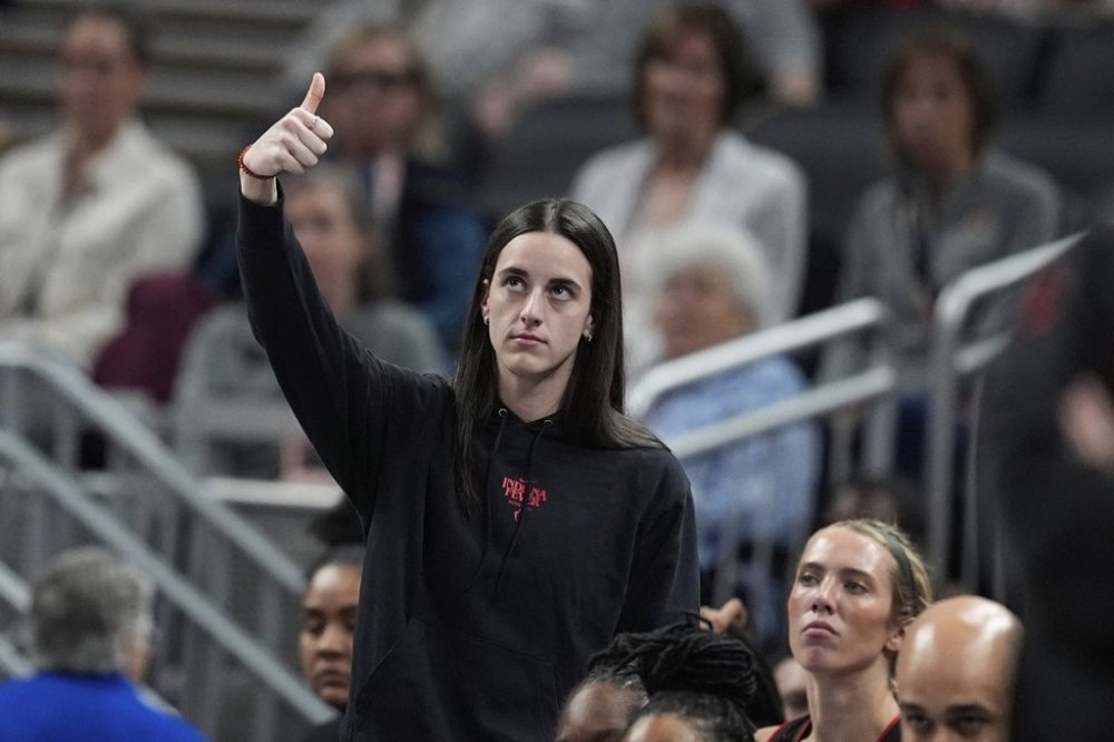 Indiana Fever's Caitlin Clark reacts on the sideline during the first half of a WNBA basketball game against the Las Vegas Aces, Thursday, July 24, 2025, in Indianapolis. (AP Photo/Darron Cummings)