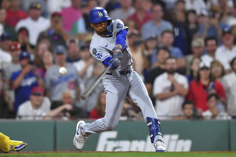 Los Angeles Dodgers' Mookie Betts swings at a pitch during an at-bat in the ninth inning of a baseball game against the Boston Red Sox, Saturday, July 26, 2025, in Boston. (AP Photo/Steven Senne)