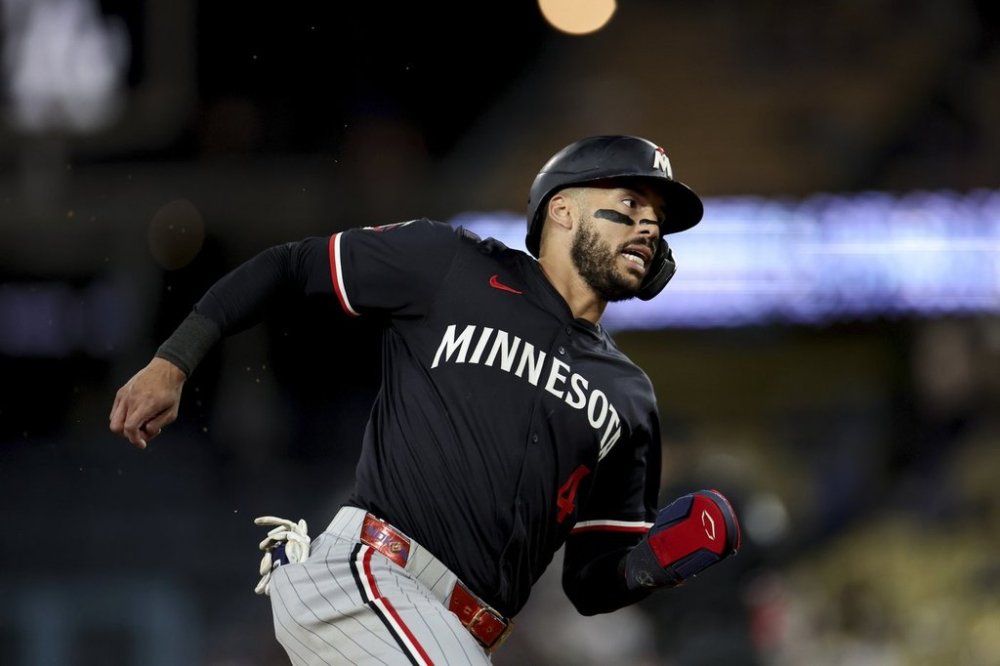 Minnesota Twins' Carlos Correa runs towards home plate during the ninth inning of a baseball game against the Los Angeles Dodgers Tuesday, July 22, 2025, in Los Angeles. (AP Photo/Eric Thayer)