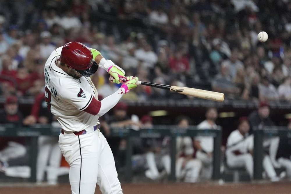 Arizona Diamondbacks' Lourdes Gurriel Jr. connects for a run-scoring single against the San Diego Padres during the fourth inning of a baseball game Monday, Aug. 4, 2025, in Phoenix. (AP Photo/Ross D. Franklin)