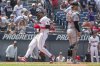 Cleveland Guardians' Angel Martinez, left, scores on a sacrifice fly by Nolan Jones as Baltimore Orioles' Alex Jackson looks towards the field during the third inning of a baseball game, Thursday, July 24, 2025, in Cleveland. (AP Photo/Phil Long)