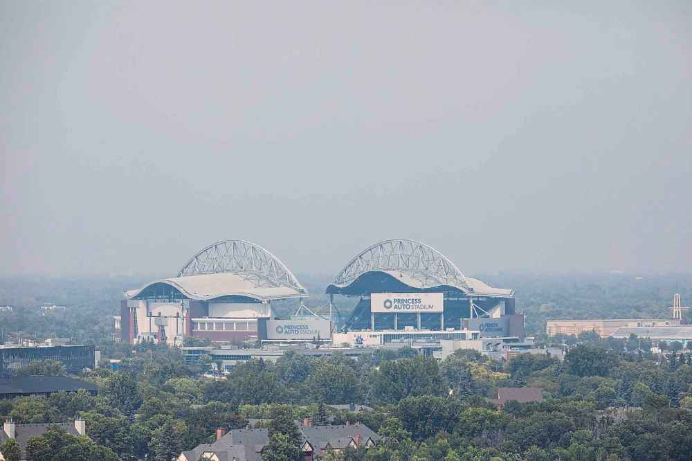 MIKAELA MACKENZIE / FREE PRESS
Smoke hangs over Princess Auto Stadium on Friday.