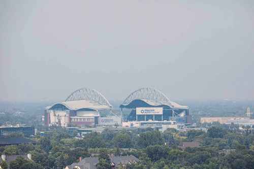 MIKAELA MACKENZIE / FREE PRESS
Smoke hangs over Princess Auto Stadium on Friday.