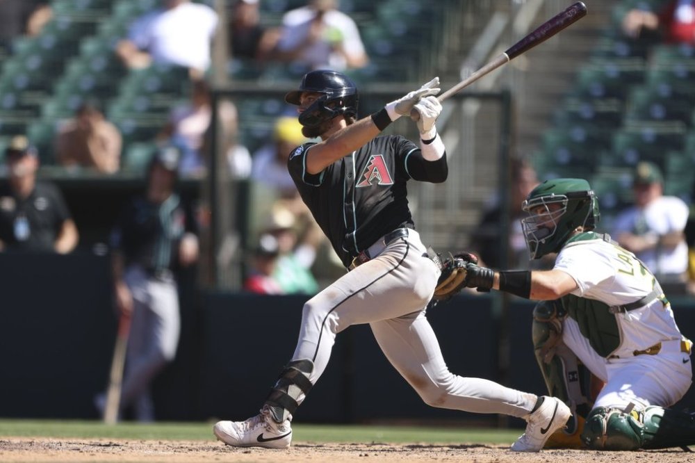 Arizona Diamondbacks' Blaze Alexander hits a single that scored a run during the ninth inning of a baseball game against the Athletics, Sunday, Aug. 3, 2025, in West Sacramento, Calif. (AP Photo/Scott Marshall)