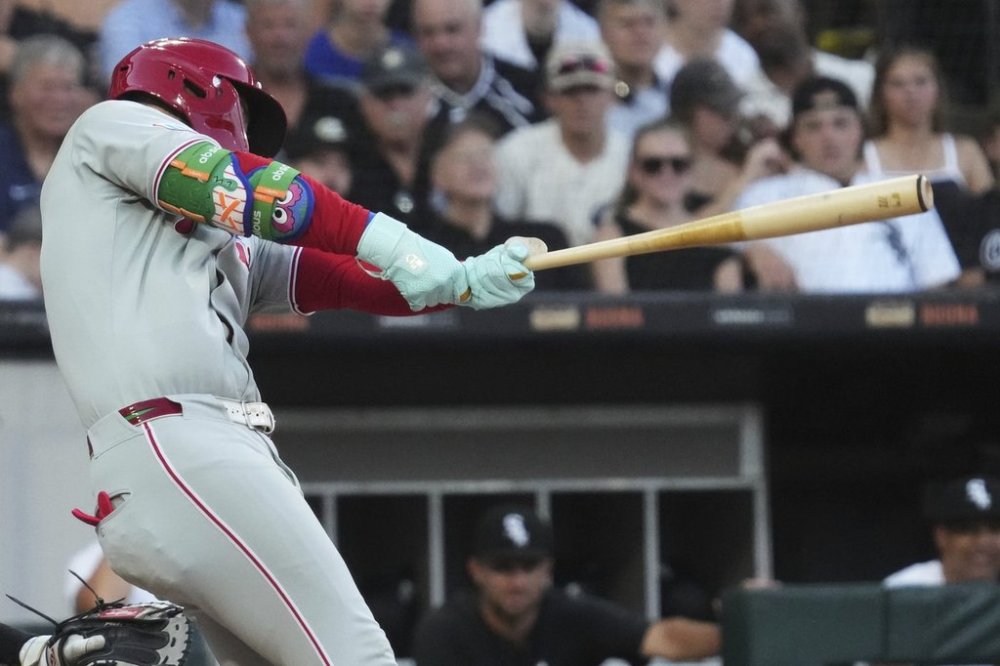 Philadelphia Phillies' Bryce Harper hits a two-run double during the third inning of a baseball game against the Chicago White Sox in Chicago, Monday, July 28, 2025. (AP Photo/Nam Y. Huh)
