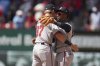 Atlanta Braves' Ozzie Albies and Luke Williams (37) celebrate a victory over the St. Louis Cardinals following a baseball game Saturday, July 12, 2025, in St. Louis. (AP Photo/Jeff Roberson)