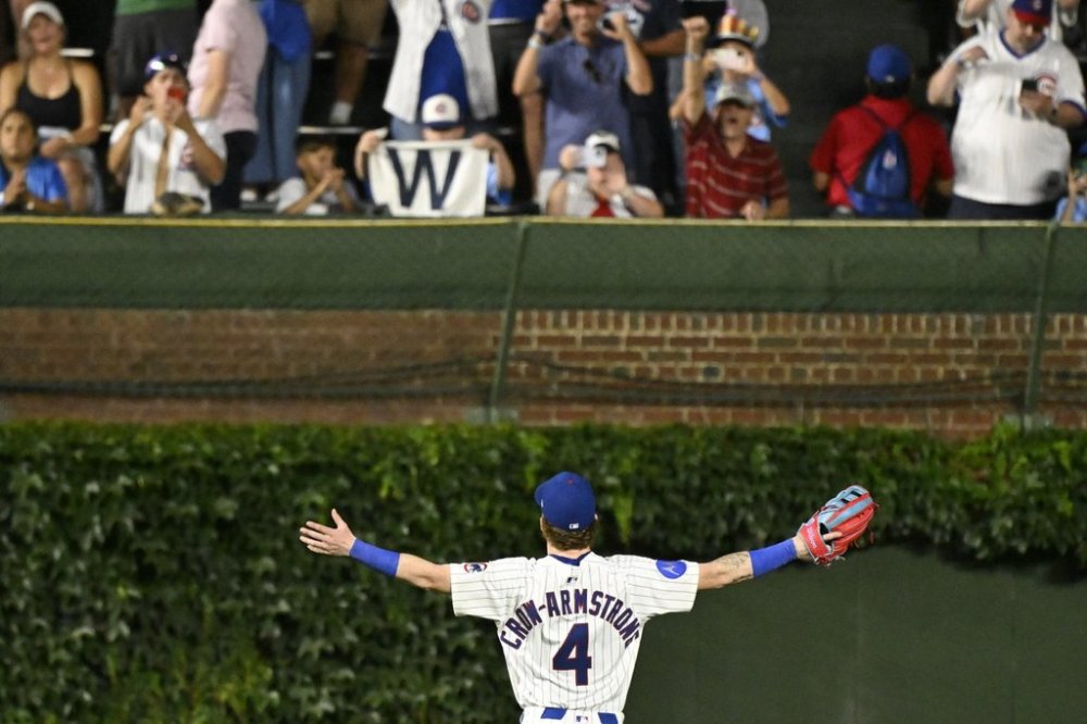 Chicago Cubs outfielder Pete Crow-Armstrong (4) greets fans after a baseball game against the Boston Red Sox, Saturday, July 19, 2025, in Chicago. (AP Photo/Matt Marton)