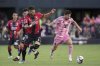 Inter Miami forward Lionel Messi, right, is pursued by Atlas defender Doria (5) during the first half of a Leagues Cup group stage soccer match, Wednesday, July 30, 2025, in Fort Lauderdale, Fla. (AP Photo/Rebecca Blackwell)