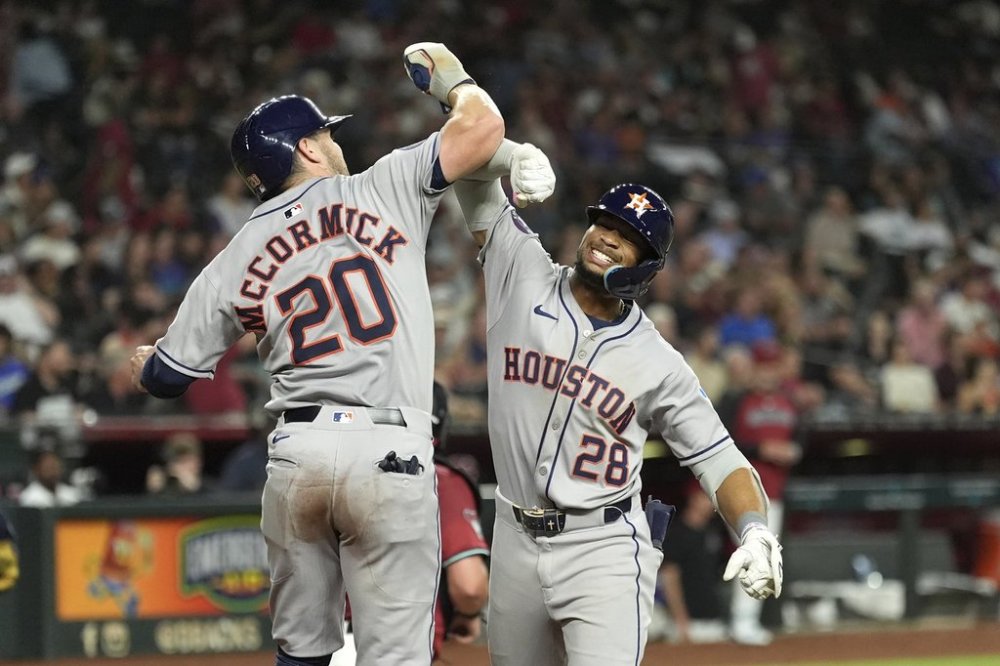 Houston Astros' Brice Matthews (28) celebrates his two-run home run against the Arizona Diamondbacks with Astros' Chas McCormick (20) during the seventh inning of a baseball game Monday, July 21, 2025, in Phoenix. (AP Photo/Ross D. Franklin)