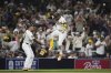 San Diego Padres' Luis Arraez, right, celebrates with third base coach Tim Leiper after hitting a two-run home run during the fifth inning of a baseball game against the New York Mets Monday, July 28, 2025, in San Diego. (AP Photo/Gregory Bull)