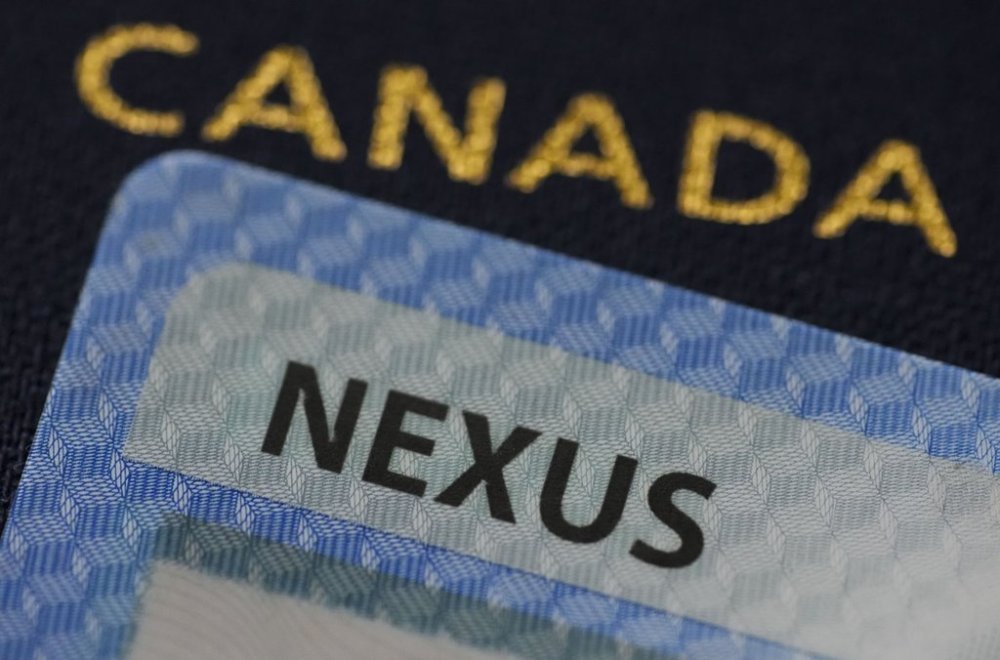 A NEXUS card and a Canadian passport are pictured in Ottawa on Tuesday, Jan. 17, 2023. THE CANADIAN PRESS/Sean Kilpatrick