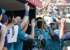 Seattle Mariners' Jorge Polanco celebrates in the dugout after hitting a solo home run to take a lead against the Detroit Tigers during the ninth inning of a baseball game, Sunday, July 13, 2025, in Detroit. (AP Photo/Duane Burleson)