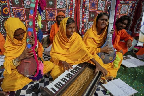 Pakistani folk musician Sham Bhai, second from right, performs with her team members at a village in Umerkot, a district of Pakistan's southeastern Sindh province, Thursday, July 17, 2025. (AP Photo/Fareed Khan)