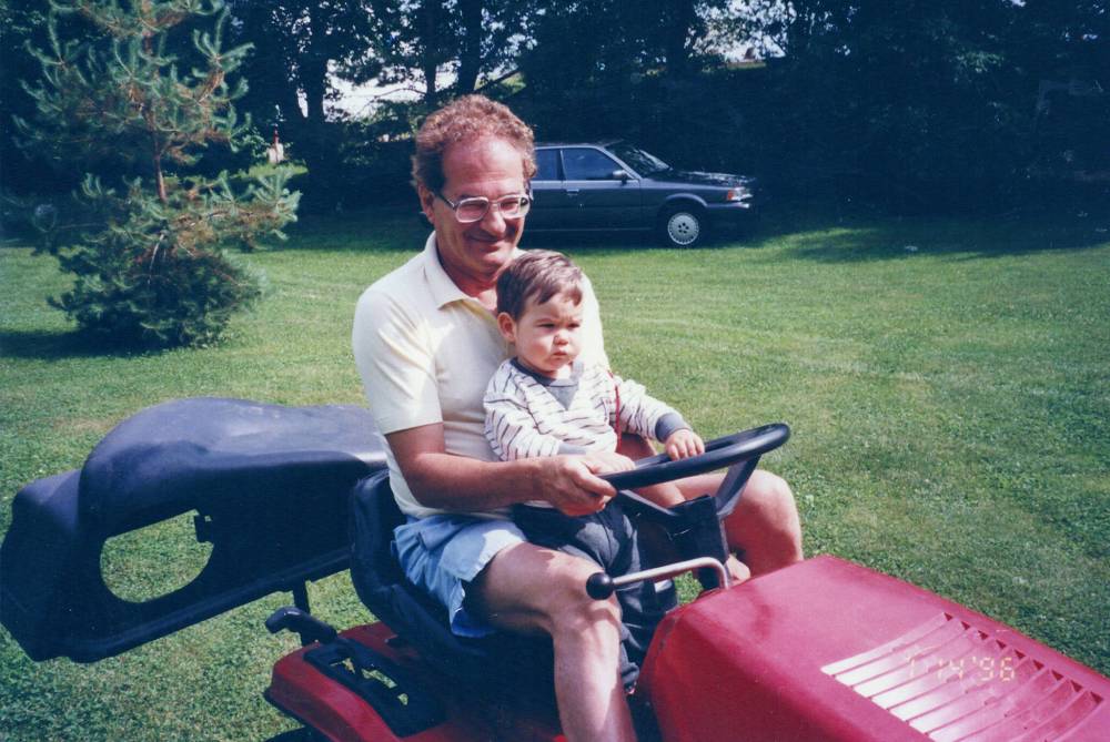 SUPPLIED
Gerry Dorge, seen here giving his eldest grandson, Alix, a spin on the riding mower, died in January at the age of 80.