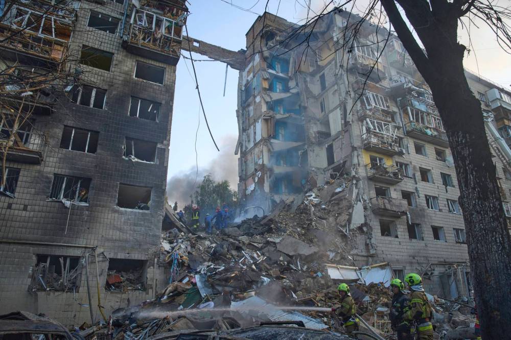Efrem Lukatsky / The Associated Press
Firefighters put out the fire after a Russian missile hit a residential building during Russia’s combined missile and drone air attack in Kyiv, Ukraine, on June 17.