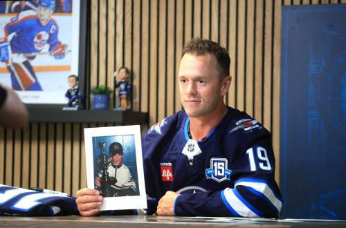 RUTH BONNEVILLE / FREE PRESS FILES
                                Jonathan Toews holds a photo of himself as a young hockey player during the press conference on Friday at Canada Life Centre.