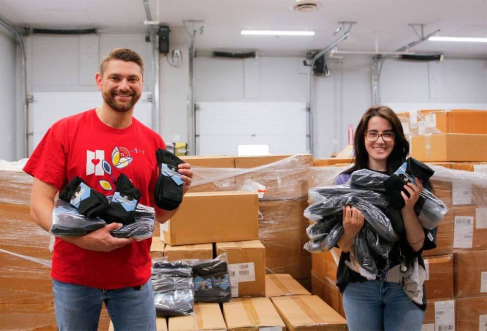 SUPPLIED
Bill Heil (left) and Kendall Giilck with some of the 40,000 pairs of new socks from Calgary-based business Sock Rocket.