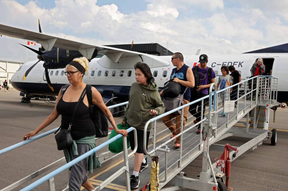 Tim Smith/The Brandon Sun
                                Evacuees from Lynn Lake arrive at Brandon Municipal Airport Friday afternoon after being evacuated due to wildfires threatening the community. This is the second time this year the Maniotba community has been evacuated.
