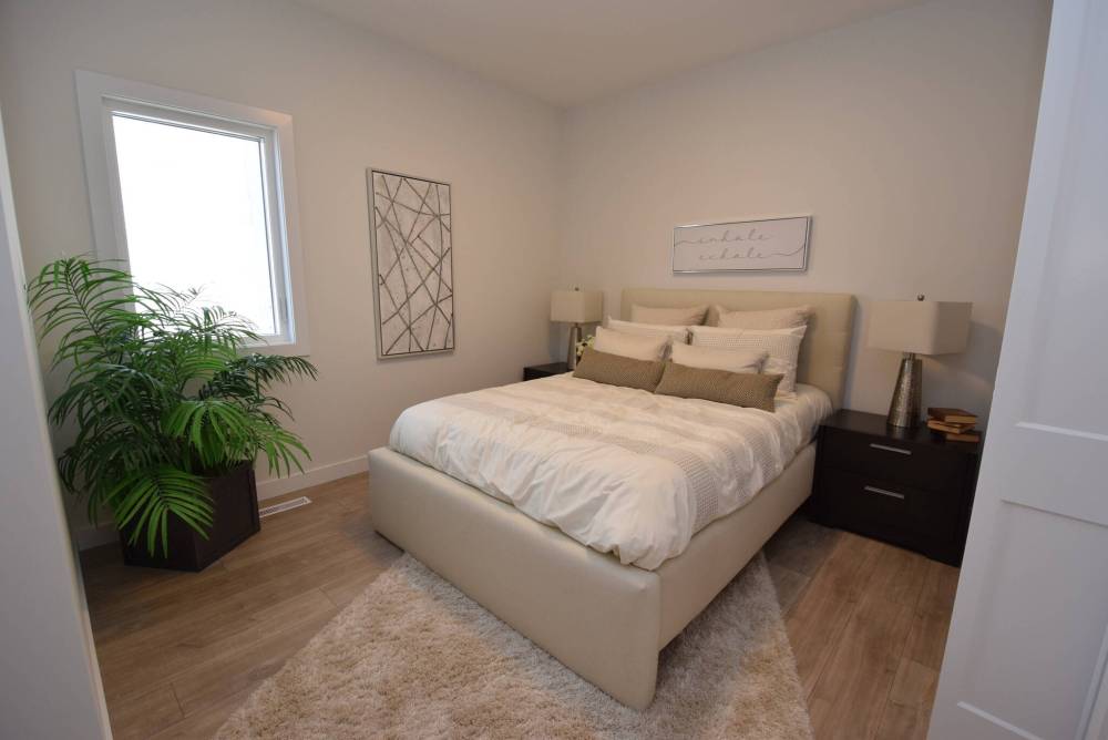 TODD LEWYS / FREE PRESS
The good-sized main floor bedroom is set back from the hallway for increased privacy.