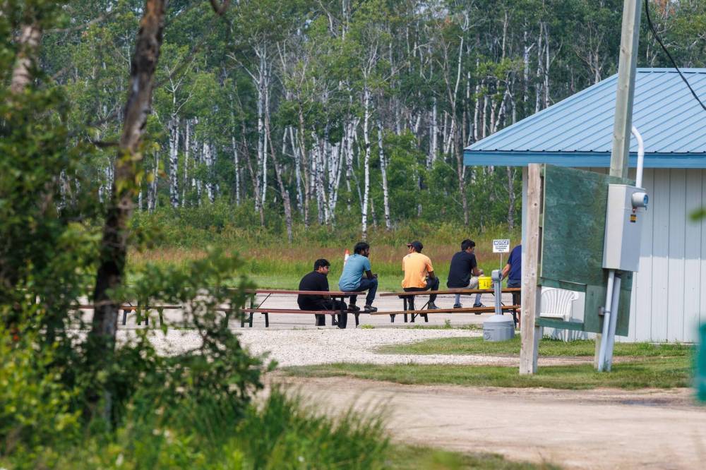 MIKE DEAL / FREE PRESS
Employees sit outside of Harv’s Air flight school just north of where the planes crashed south of Steinbach Tuesday.