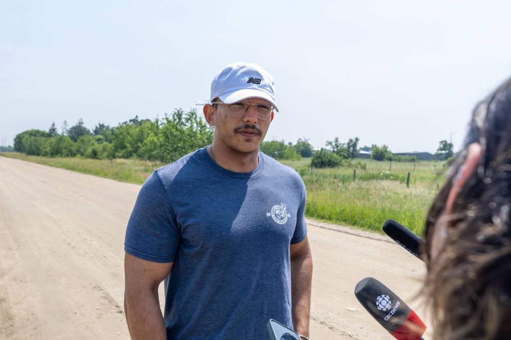 Mike Deal / Free Press
Mohamed Shahin, an instructor at Harv’s Air flight school, talks briefly to reporters near where the planes crashed on private property south of Steinbach Tuesday.