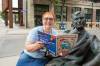 BROOK JONES/FREE PRESS
                                Winnipeg resident Wendy Molnar, 67, who is a Fringe Team Leader has been volunteering with the Winnipeg Fringe Festival for 36 years. Molnar, who is holding a Fringe program, was pictured outside the Royal Manitoba Theatre Centre next to the statue that depicts Tom Hendry who was the theatre’s first Business Manager in Winnipeg, Man., Friday, July 4, 2025.
