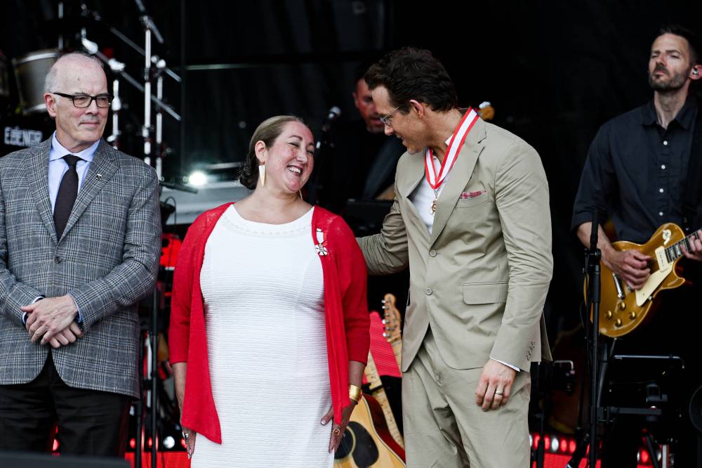 SPENCER COLBY / THE CANADIAN PRESS FILES
Scott Oake looks on as Ryan Reynolds chats with Deantha Rae Edmunds after she was invested as a Member of the Order of Canada in Ottawa on July 1.