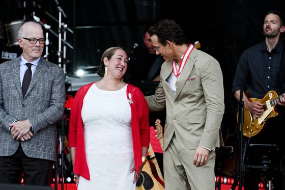 Scott Oake looks on as Ryan Reynolds chats with Deantha Rae Edmunds after she was invested as a Member of the Order of Canada in Ottawa on July 1. (Spencer Colby / The Canadian Press files)