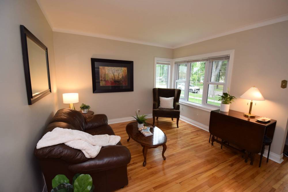 TODD LEWYS PHOTOS / FREE PRESS
Inviting and spacious, the living room at 421 Centennial St. features original maple hardwood and lovely tree views through windows on its front and side walls.