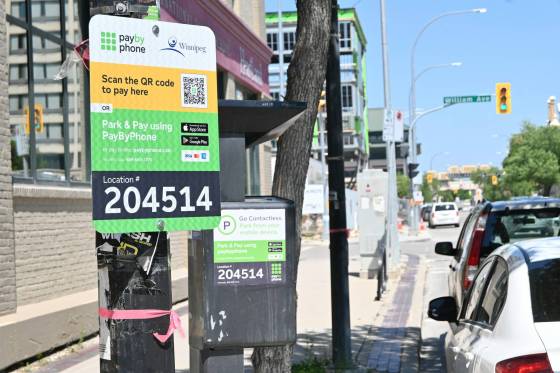 New PayByPhone app parking signs have been put up across downtown with QR codes that will direct drivers to a payment site. (Matthew Frank / Free Press)