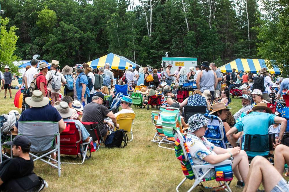 MIKAELA MACKENZIE / FREE PRESS
Lineups stretch far past the entrance before the gates open at Folk Fest on Thursday.