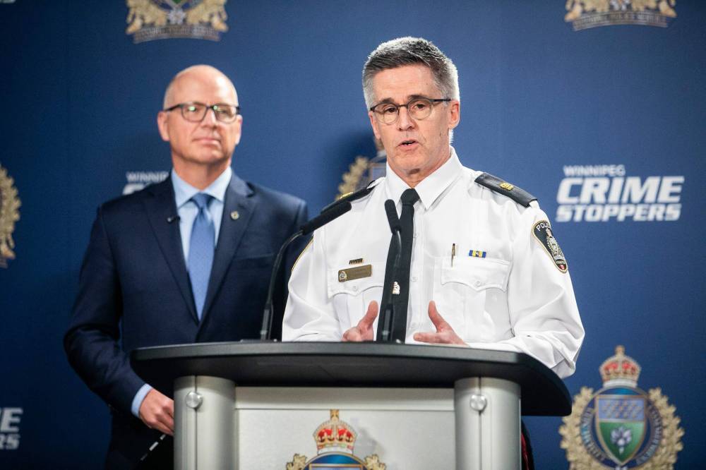 MIKAELA MACKENZIE / FREE PRESS
Inspector Gord Spado of the WPS communications division, with guest Mayor Scott Gillingham), speaks to the media about AI-powered interactive voice agents for their non-emergency line on Friday.