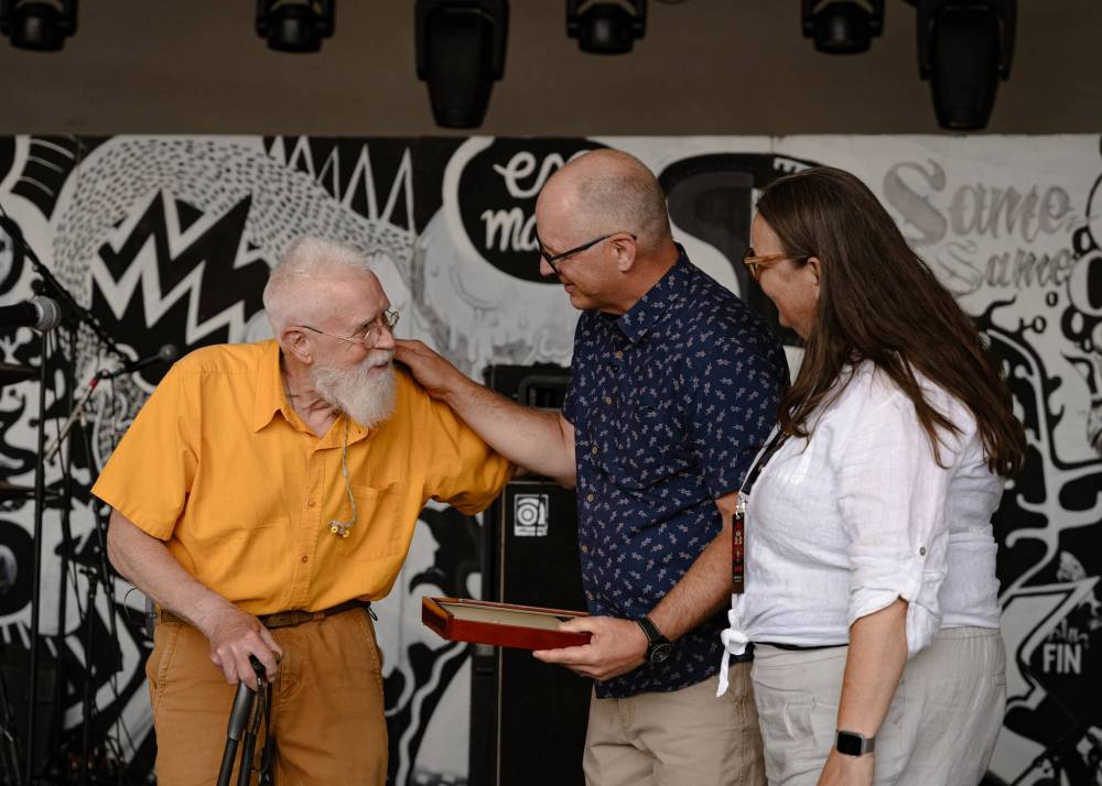 MATT HORSEMAN PHOTO
Bruce Cockburn receives a key to the City of Winnipeg at the 50th Winnipeg Folk Festival. Winnipeg Mayor Scott Gillingham (centre) and Winnipeg Folk Festival executive director Valerie Shantz (right) presented the key to the legendary Canadian musician.
