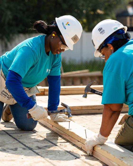 Holly Jefferson (left) and members of the Bombers Women’s Club work on a Habitat for Humanity house in Transcona last week. (Supplied)