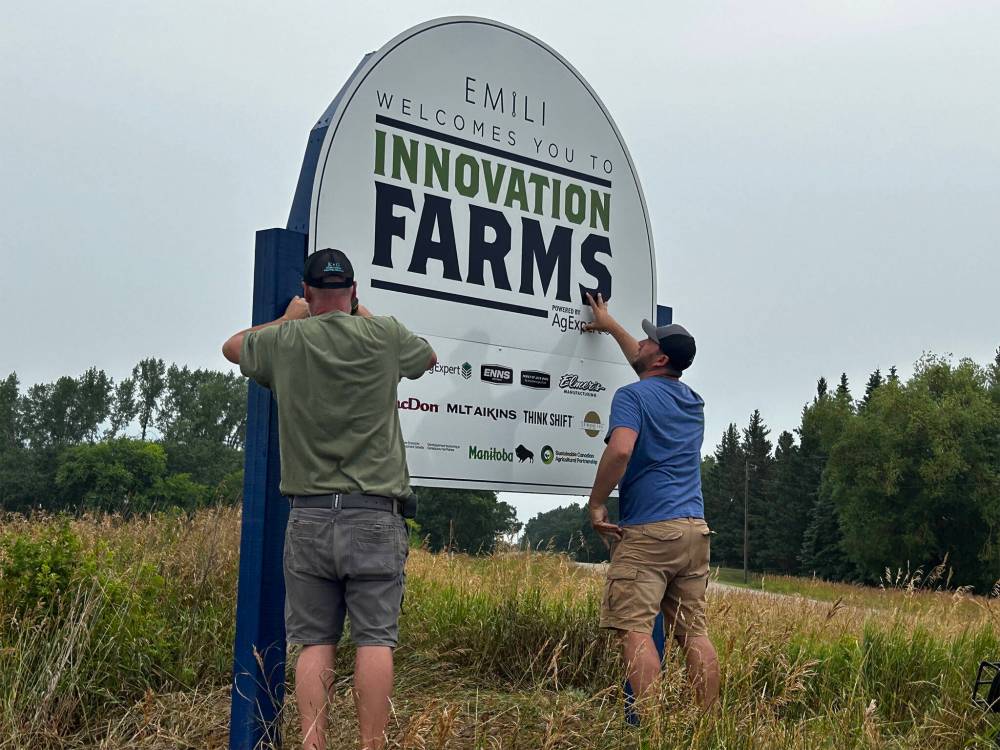 SUPPLIED
Workers install a sign at Innovation Farms’s newest expansion in MacGregor, Man. The expansion covers J.P. Wiebe Ltd., a potato farm.