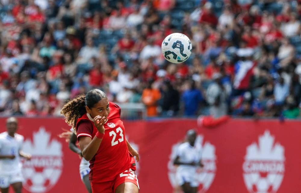JOHN WOODS / THE CANADIAN PRESS FILES
Olivia Smith heads the ball for the goal against Haiti in Winnipeg in may. She is expected to develop under Arsenal’s stars before leading the squad in a few years