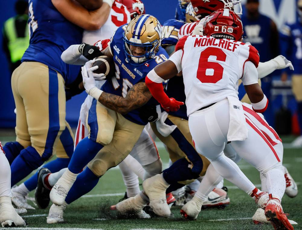 JOHN WOODS / THE CANADIAN PRESS
Winnipeg Blue Bombers’ Brady Oliveira (20) makes the first down against the Calgary Stampeders during first half CFL action in Winnipeg Friday, July 18, 2025.