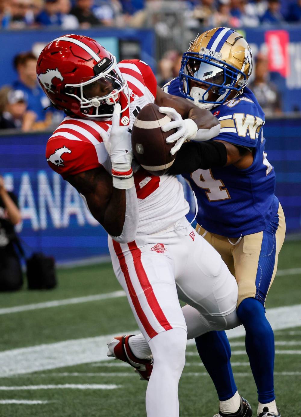 JOHN WOODS / THE CANADIAN PRESS
Calgary Stampeders’ Damien Alford (80) catches a touchdown pass against Winnipeg Blue Bombers Terrell Bonds (24) during first half CFL action in Winnipeg Friday, July 18, 2025. THE CANADIAN PRESS/John Woods