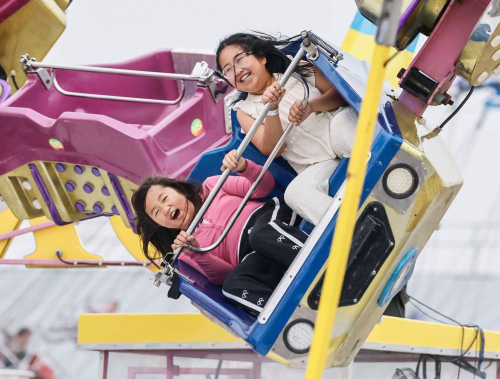 Visitors took in the rides despite the hazy conditions at the Stampede. (John Woods / Free Press)