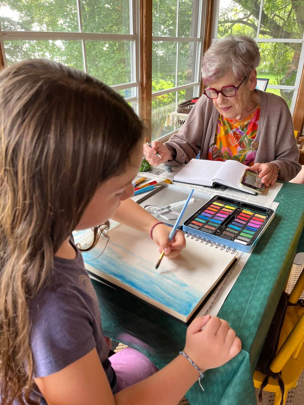 Jennifer Menzies Photo
At Ponemah Beach, Menzies and granddaughter Olivia work on art projects. Menzies took up drawing and watercolour painting in retirement.