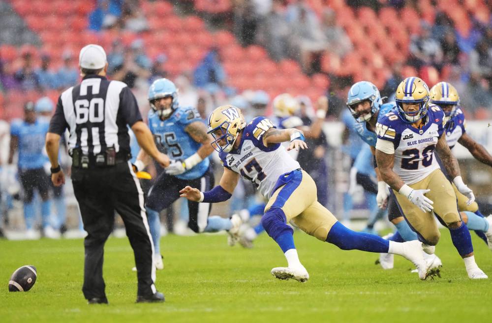 Nathan Denette / THE CANADIAN PRESS
Winnipeg Blue Bombers linebacker Tony Jones (33) tries to tackle Toronto Argonauts running back Khalan Laborn (30) during first half CFL football action in Toronto on Saturday, July 26, 2025.