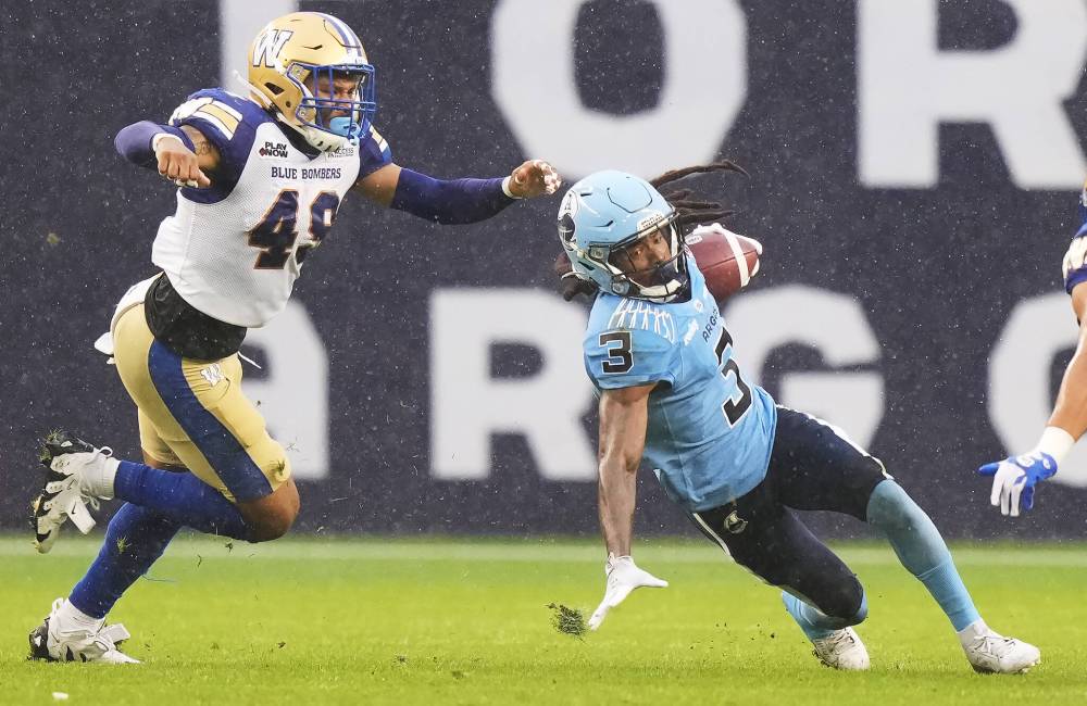 Nathan Denette / THE CANADIAN PRESS
Winnipeg Blue Bombers linebacker Michael Ayers (49) chases Toronto Argonauts wide receiver Janarion Grant (3) during first half CFL football action in Toronto on Saturday, July 26, 2025.