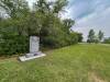 TYLER SEARLE / FREE PRESS
                                The Ten Commandments monument, which was reinstalled at a new location near a copse of trees south-east of The Leaf on July 25.250728 - Monday, July 28, 2025.