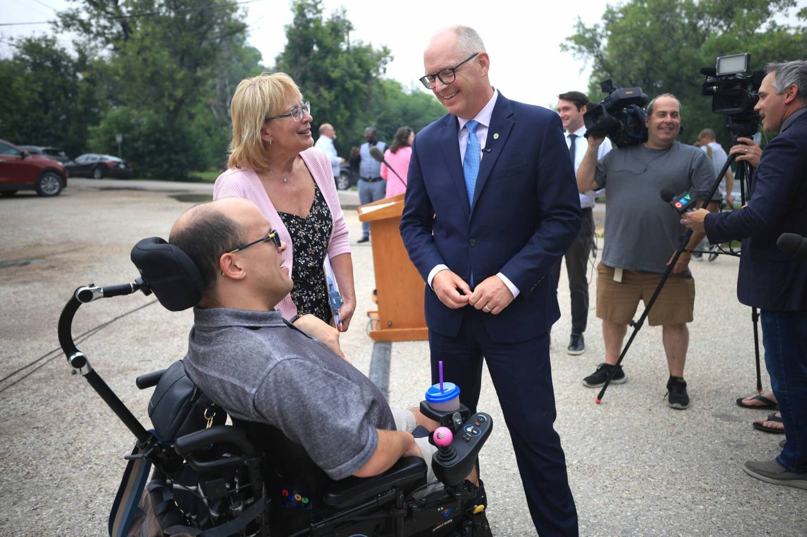 RUTH BONNEVILLE / FREE PRESS
                                Mayor Scott Gillingham talks with Bryce Nelson (wheelchair) and his mom, Margy Nelson, Special Projects Director, CoHabit, after the news conference at 825 Tache on developers selected to build affordable housing on city-owned properties.