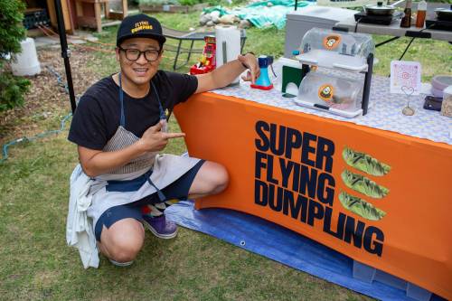 BROOK JONES / FREE PRESS
                                Aaron Li, who moved to Winnipeg with his family in 2022, markets Chinese dumplings based on family recipes and sells his dumplins at the Wolseley Farmers Market at Saint Margaret&rsquo;s Anglican Church in Winnipeg, Man. Li has a variety of dumplings such as pork with cabbage and chive, tofu with kimchi and beef with carrots and onion. Pictured: Li, 37, shows enthusiasm for his Super Flying Dumpling booth during the Wolseley Farmers Market Tuesday, July 29, 2025.