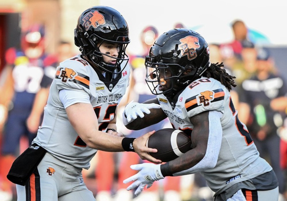 B.C. Lions quarterback Nathan Rourke (12) hands off to James Butler (20) during first half CFL football action against the Montreal Alouettes in Montreal, Saturday, July 5, 2025. THE CANADIAN PRESS/Graham Hughes
