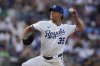Kansas City Royals starting pitcher Rich Hill throws during the first inning of a baseball game against the Atlanta Braves, Monday, July 28, 2025, in Kansas City, Mo. (AP Photo/Charlie Riedel)
