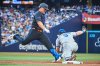 Toronto Blue Jays Outfielder Daulton Varsho (5) is out as Kansas City Royals first base Vinnie Pasquantino (9) makes a catch during fourth inning MLB baseball action in Toronto, Friday, Aug. 1, 2025. THE CANADIAN PRESS/Sammy Kogan