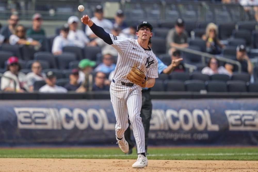 New York Yankees third baseman Ryan McMahon (19) throws out Philadelphia Phillies' Otto Kemp at first base during the eighth inning of a baseball game, Saturday, July 26, 2025, in New York. (AP Photo/Yuki Iwamura)