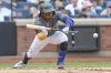 New York Mets' Luisangel Acuña (2) hits a sacrifice bunt in the third inning of a baseball game against the Cincinnati Reds, Sunday, July 20, 2025, in New York. (AP Photo/Heather Khalifa)